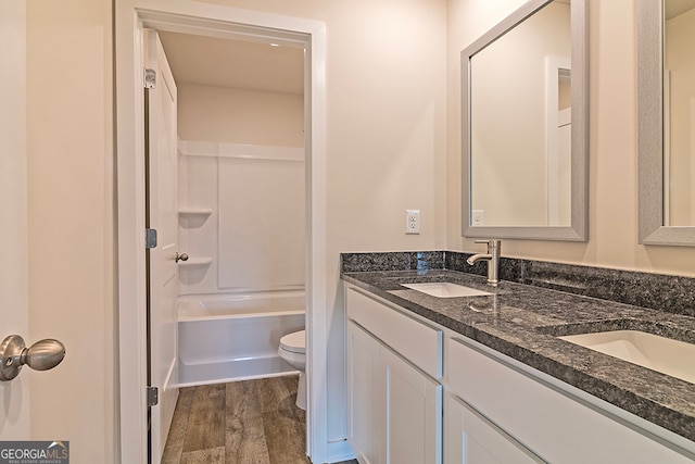 full bathroom featuring vanity, shower / washtub combination, hardwood / wood-style floors, and toilet