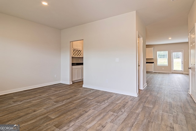 unfurnished room with wood-type flooring