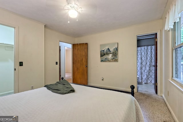 carpeted bedroom featuring ceiling fan, a closet, connected bathroom, and a spacious closet