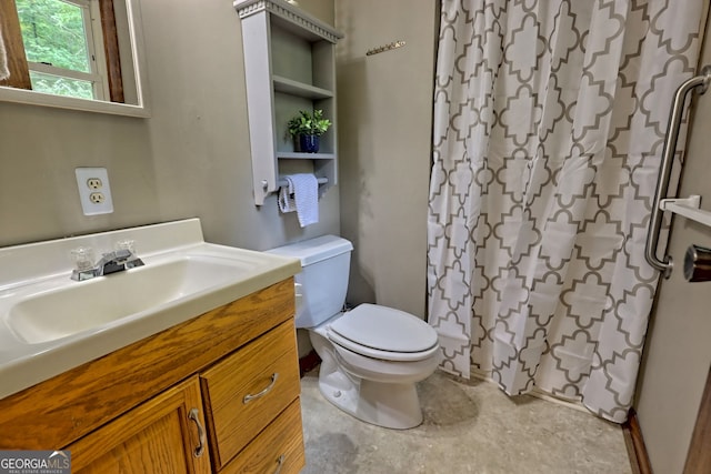 bathroom with toilet, vanity, and curtained shower