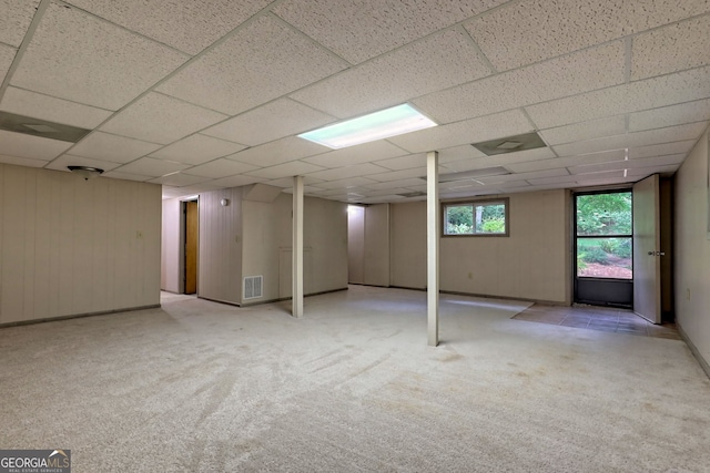 basement with light carpet and a drop ceiling