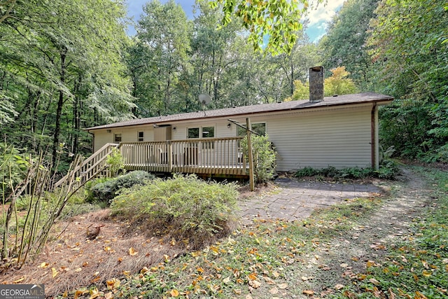 back of house featuring a wooden deck