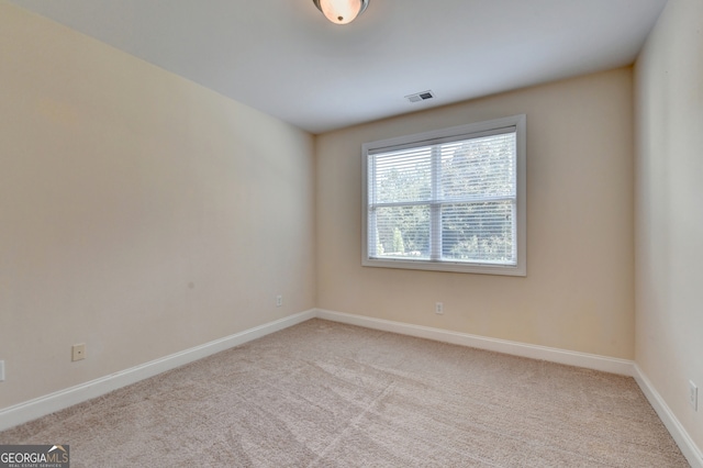 empty room featuring light carpet