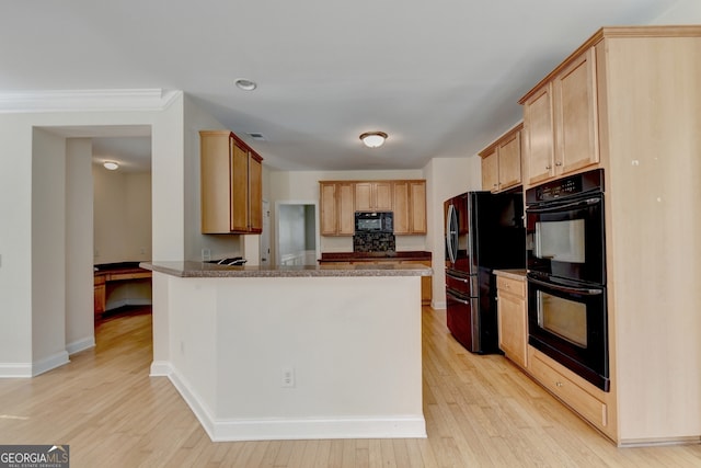 kitchen featuring black appliances, light hardwood / wood-style floors, light brown cabinets, and kitchen peninsula