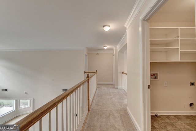 hall with light carpet and ornamental molding