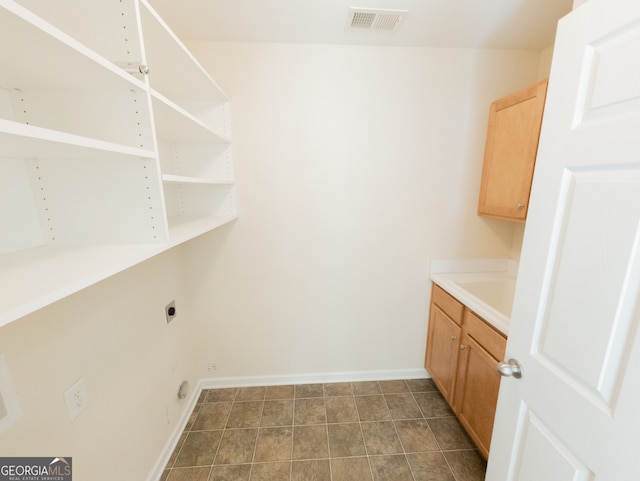 laundry room featuring cabinets and electric dryer hookup