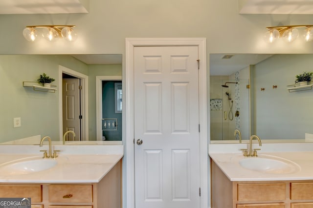 bathroom with tiled shower and vanity