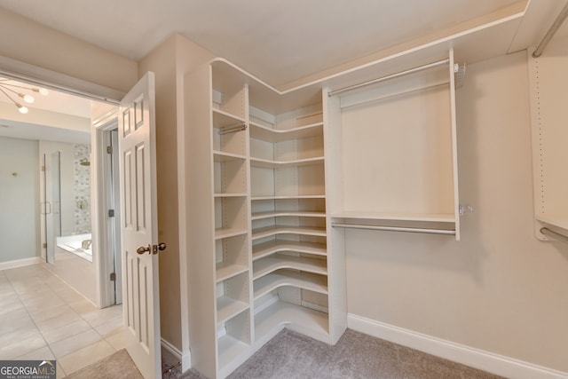 spacious closet featuring light tile patterned floors