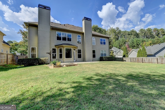 rear view of property featuring a yard