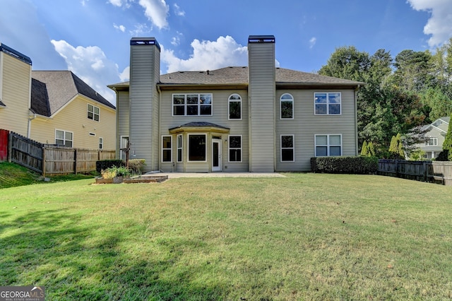 back of house with a yard and a patio area