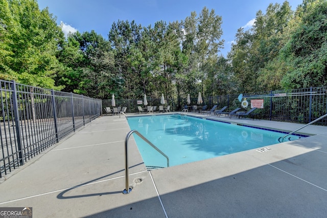 view of swimming pool with a patio area