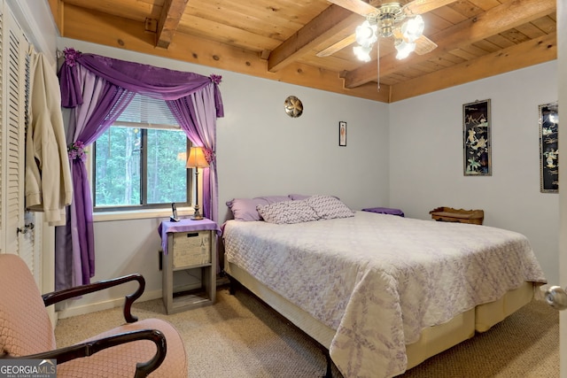 carpeted bedroom with wood ceiling, beamed ceiling, and ceiling fan