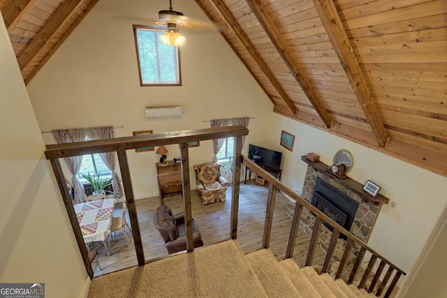 staircase with wood-type flooring, vaulted ceiling with beams, an AC wall unit, and wooden ceiling