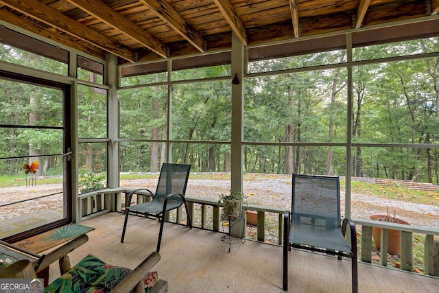 unfurnished sunroom with wood ceiling and beam ceiling