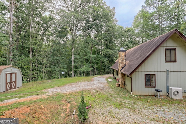 view of yard featuring a shed and ac unit