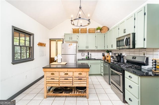 kitchen featuring light tile patterned floors, tasteful backsplash, appliances with stainless steel finishes, and a sink