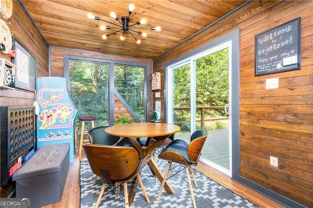 sunroom featuring wooden ceiling and a notable chandelier