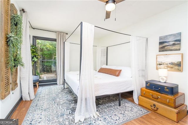 bedroom with a ceiling fan and wood finished floors