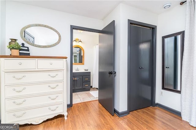 interior space featuring light wood-style flooring and baseboards