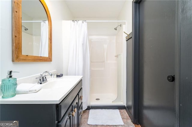 bathroom featuring a stall shower and vanity