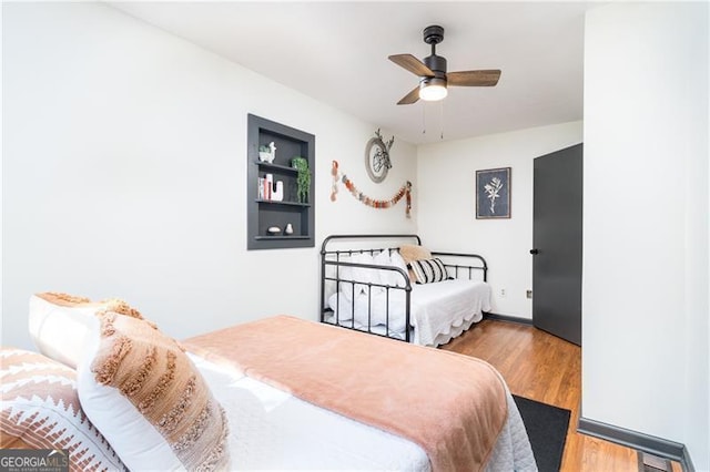 bedroom with a ceiling fan and wood finished floors