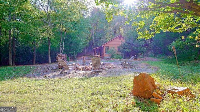 view of yard with an outdoor fire pit