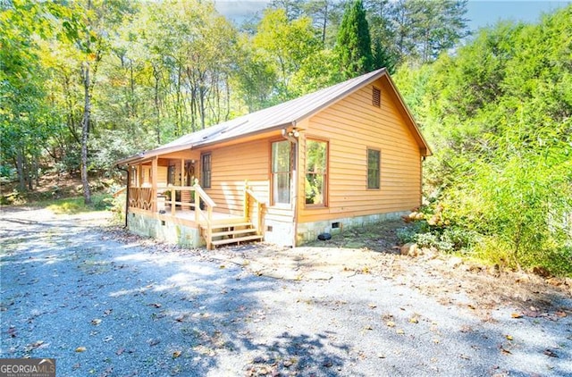 view of front of property with crawl space and a deck