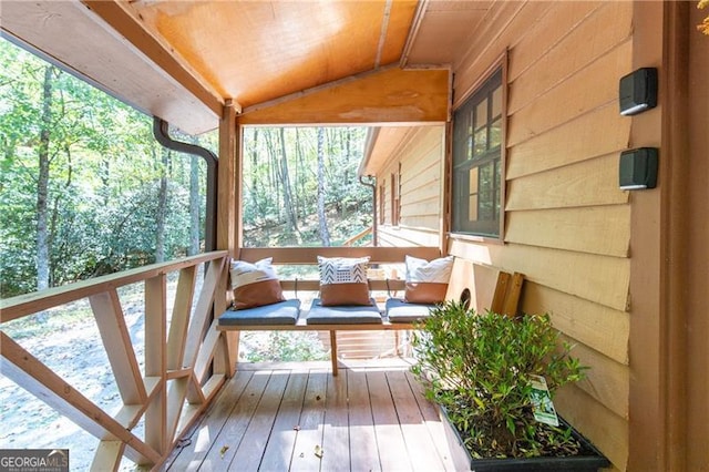 sunroom featuring vaulted ceiling