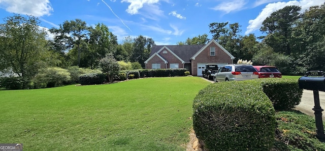 view of front of home with a garage and a front lawn