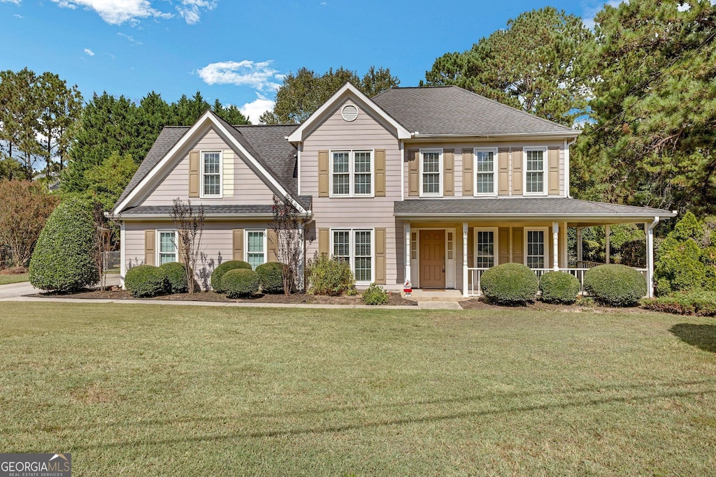 view of front facade featuring a porch and a front lawn