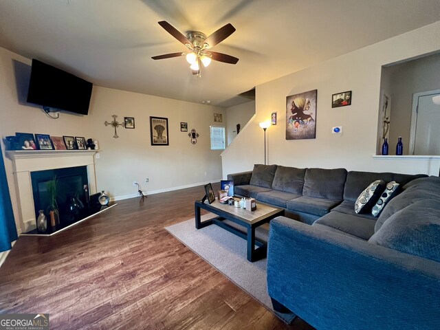 living room with ceiling fan and hardwood / wood-style flooring