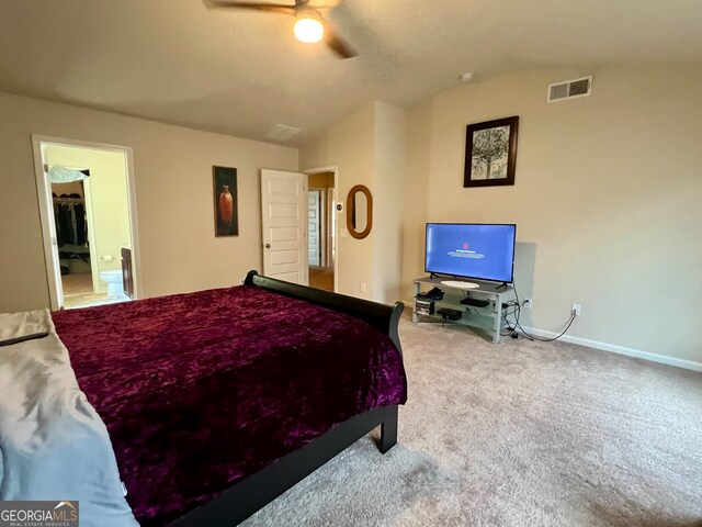 carpeted bedroom featuring lofted ceiling, ceiling fan, and ensuite bathroom