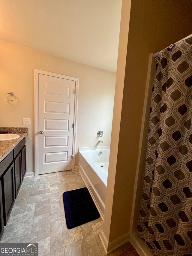 bathroom featuring a tub and vanity