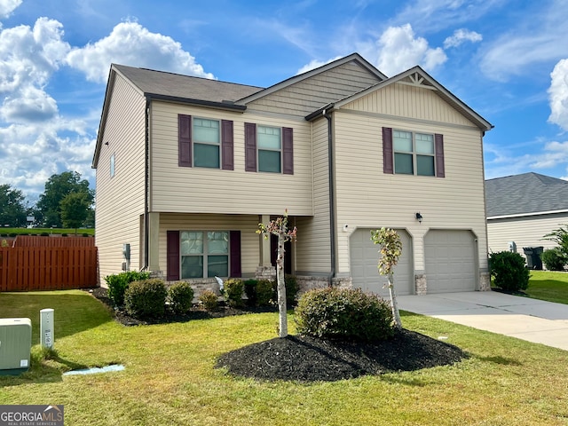 view of front of property featuring a garage and a front yard