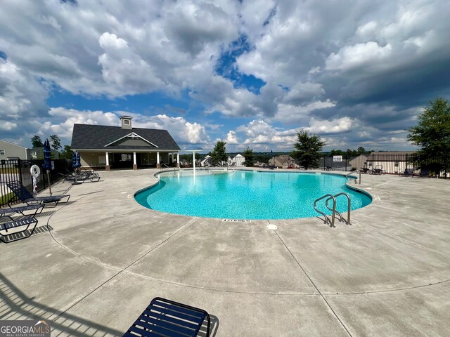 view of swimming pool with a patio