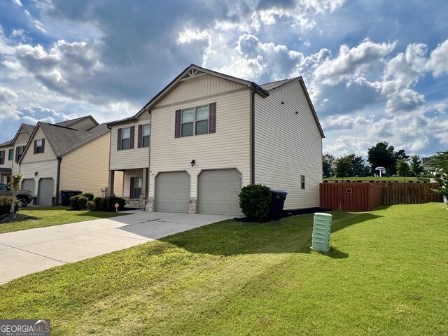 view of front of house with a garage and a front yard