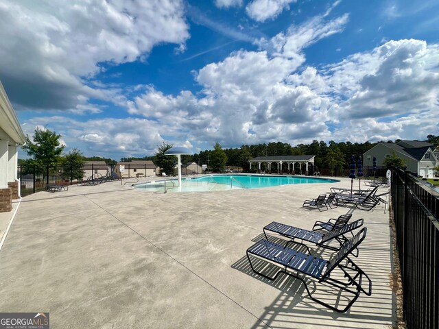 view of swimming pool with a patio