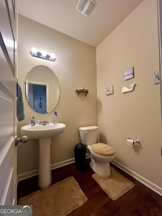 bathroom featuring hardwood / wood-style floors and toilet