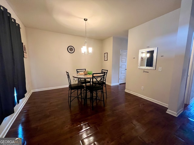 dining room with an inviting chandelier and dark hardwood / wood-style flooring