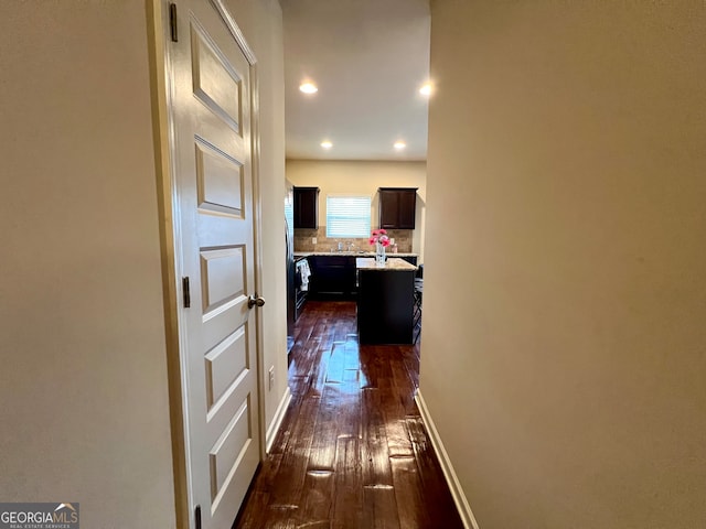 hallway with dark hardwood / wood-style flooring