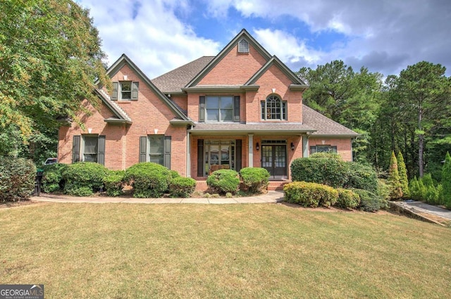 view of front of property featuring covered porch and a front yard