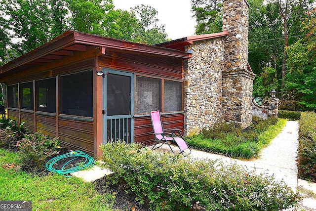 view of side of property featuring a sunroom