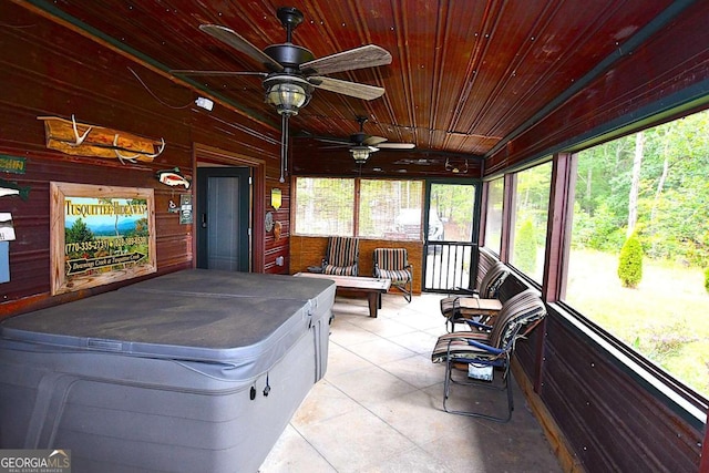 sunroom / solarium featuring wooden ceiling, a healthy amount of sunlight, lofted ceiling, and ceiling fan