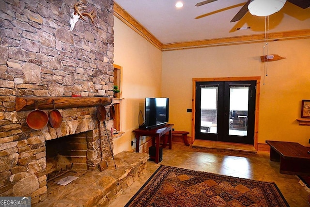 interior space featuring a stone fireplace, ornamental molding, and ceiling fan