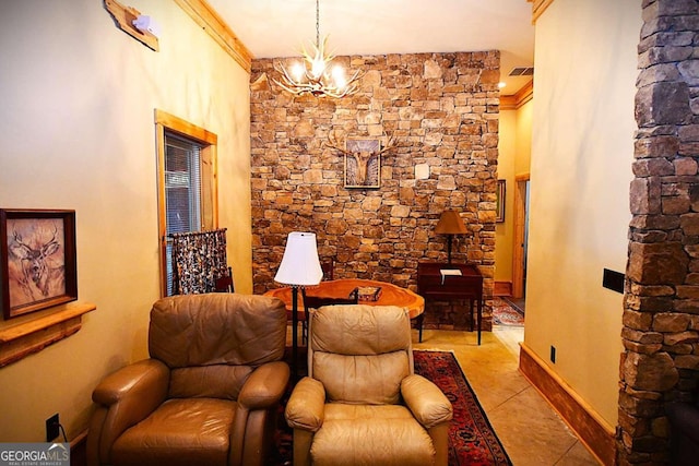 living area with light tile patterned floors, a chandelier, and ornamental molding