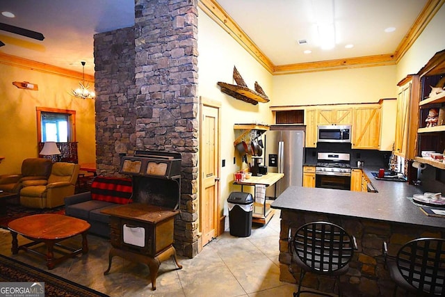 kitchen featuring kitchen peninsula, stainless steel appliances, light tile patterned floors, ornamental molding, and light brown cabinetry