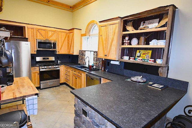 kitchen featuring light tile patterned flooring, ornamental molding, sink, backsplash, and appliances with stainless steel finishes