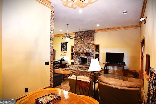 living room featuring crown molding, a fireplace, and ceiling fan