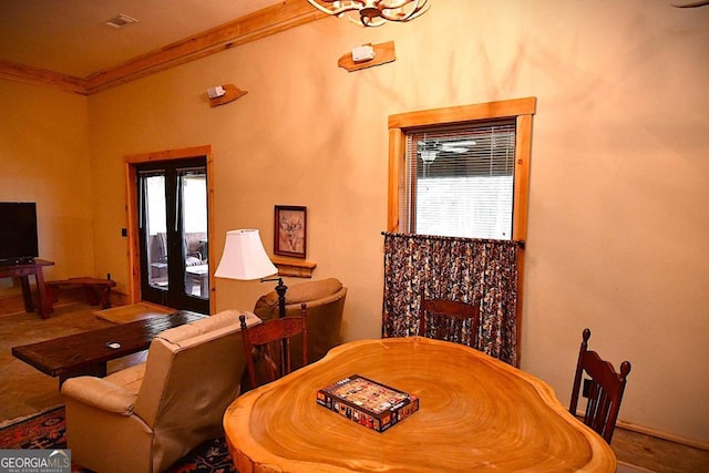 dining room featuring a healthy amount of sunlight and crown molding