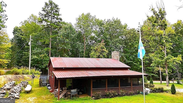 exterior space with a lawn and an outdoor structure